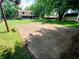 Expansive backyard features a basketball court, mature trees, and plenty of green space for outdoor activities at 336 N Windsong Ln, Greenwood, IN 46142