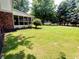 Lush green backyard with mature trees offers a serene and private outdoor space at 336 N Windsong Ln, Greenwood, IN 46142