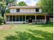 Spacious backyard showcasing a home with a covered porch, offering a serene view of the lush lawn and mature trees at 336 N Windsong Ln, Greenwood, IN 46142