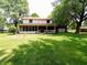 Inviting two-story home featuring a large, shaded backyard with a covered porch, perfect for relaxing and outdoor entertaining at 336 N Windsong Ln, Greenwood, IN 46142