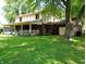 Beautiful backyard with a covered porch, mature trees, and ample space for gardening and outdoor recreation at 336 N Windsong Ln, Greenwood, IN 46142
