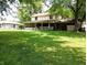 Well-maintained backyard featuring a covered porch and mature trees, offering a tranquil and spacious outdoor retreat at 336 N Windsong Ln, Greenwood, IN 46142