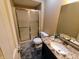 Bathroom with granite countertop, stainless faucet, shower stall, and tile floor at 336 N Windsong Ln, Greenwood, IN 46142