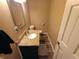 Cozy half-bathroom featuring granite countertops, sleek fixtures and hardwood flooring at 336 N Windsong Ln, Greenwood, IN 46142