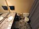 Bathroom features a granite countertop, a stainless steel trash can, and dark gray tiled flooring at 336 N Windsong Ln, Greenwood, IN 46142