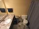 Bathroom features a granite countertop, a stainless steel trash can, and dark gray tiled flooring at 336 N Windsong Ln, Greenwood, IN 46142