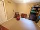 Bedroom featuring tan walls, carpeted floor, a leather chair, and storage shelf at 336 N Windsong Ln, Greenwood, IN 46142