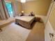 Cozy bedroom featuring a comfortable bed, soft carpet, and a bright window with plenty of natural light at 336 N Windsong Ln, Greenwood, IN 46142