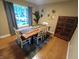 Well-lit dining room features hardwood floors, a rustic table, and tasteful decor at 336 N Windsong Ln, Greenwood, IN 46142