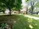 Spacious home with a large front yard, mature trees, and a long driveway at 336 N Windsong Ln, Greenwood, IN 46142