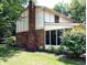 Exterior view highlighting the brick accents, large chimney, and screened-in porch at 336 N Windsong Ln, Greenwood, IN 46142