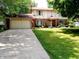 Traditional two-story home featuring a spacious driveway, attached garage, and a well-maintained front lawn at 336 N Windsong Ln, Greenwood, IN 46142