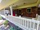 Inviting covered front porch with white railing and brick accents provides a cozy outdoor space at 336 N Windsong Ln, Greenwood, IN 46142