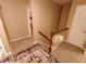 Hallway with a decorative rug, wood banister, and neutral colored walls leading to the bedrooms at 336 N Windsong Ln, Greenwood, IN 46142