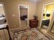 Neutral hallway with a decorative rug features entries into the bathroom and a bedroom with a chair and ottoman at 336 N Windsong Ln, Greenwood, IN 46142