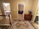 Upstairs hallway with decorative rug leading to the bedrooms and bathrooms of the home with neutral walls at 336 N Windsong Ln, Greenwood, IN 46142
