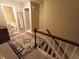 Hallway at the top of the stairs features a decorative rug, neutral walls, and views to the bathroom at 336 N Windsong Ln, Greenwood, IN 46142