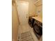 A well-lit laundry room with modern washer and dryer and a wooden countertop at 336 N Windsong Ln, Greenwood, IN 46142