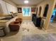 Open living area with skylight, seating, and view of the fireplace beyond at 336 N Windsong Ln, Greenwood, IN 46142