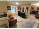 Open living area with skylight, seating, and view of the fireplace beyond at 336 N Windsong Ln, Greenwood, IN 46142