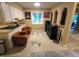 Open living area with skylight, seating, and view of the fireplace beyond at 336 N Windsong Ln, Greenwood, IN 46142