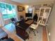 A home office with a large desk, computer monitor, and natural light from the nearby window at 336 N Windsong Ln, Greenwood, IN 46142