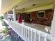 Cozy screened-in porch with wood flooring, brick accents, and comfortable seating offers a relaxing outdoor space at 336 N Windsong Ln, Greenwood, IN 46142