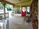 Inviting screened-in porch with red door, white railing, and ample space for outdoor relaxation and entertaining at 336 N Windsong Ln, Greenwood, IN 46142