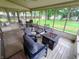 Cozy screened-in porch with comfortable seating around a fire pit offering views of the well-maintained backyard at 336 N Windsong Ln, Greenwood, IN 46142