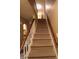 Carpeted staircase with wooden railing provides access to the home's upper level at 336 N Windsong Ln, Greenwood, IN 46142
