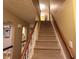 Carpeted staircase with wooden railing provides access to the home's upper level at 336 N Windsong Ln, Greenwood, IN 46142
