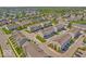 An aerial view of a new development featuring perfectly aligned townhomes, sidewalks, and community ponds at 3546 Brampton Ln, Westfield, IN 46074