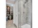 Shower detail with a modern dual shower head and a glimpse into a well-organized walk-in closet at 3546 Brampton Ln, Westfield, IN 46074