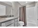 A well-lit bathroom includes a single sink vanity and a shower-tub combination with a gray shower curtain at 3546 Brampton Ln, Westfield, IN 46074