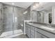 Elegant bathroom with a double sink vanity, walk-in shower with glass door, and modern gray tile at 3546 Brampton Ln, Westfield, IN 46074