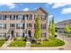 Charming brick and siding townhouse with a well-manicured lawn and inviting front entrance on a beautiful, sunny day at 3546 Brampton Ln, Westfield, IN 46074