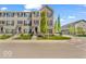 Charming three-story brick townhome with manicured landscaping, creating inviting curb appeal at 3546 Brampton Ln, Westfield, IN 46074