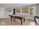 Spacious game room featuring a pool table, wood-look floors, and ample natural light at 3546 Brampton Ln, Westfield, IN 46074
