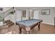 Bright game room boasts a pool table, wood floors, and easy access to other areas of the home at 3546 Brampton Ln, Westfield, IN 46074