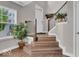Inviting interior entryway with wood flooring, staircase with iron railing, and natural light from a large window at 3546 Brampton Ln, Westfield, IN 46074