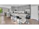 Kitchen with an island featuring bar stool seating, grey cabinets, stainless steel appliances, and white subway tile backsplash at 3546 Brampton Ln, Westfield, IN 46074
