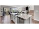 Kitchen with an undermount sink in a white quartz countertop with views of the living room with patio door access at 3546 Brampton Ln, Westfield, IN 46074