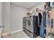 Functional laundry room with modern side-by-side washer and dryer and convenient shelving for storage at 3546 Brampton Ln, Westfield, IN 46074