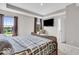 Bright main bedroom featuring a tray ceiling, large windows, and a wall-mounted TV, creating a relaxing retreat at 3546 Brampton Ln, Westfield, IN 46074