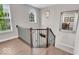 Staircase with hardwood floors and natural light shining through a large window, showing a view of the house across the street at 3546 Brampton Ln, Westfield, IN 46074
