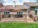 Wooden back deck with patio furniture and an umbrella, ideal for outdoor dining and relaxation at 3559 Towne Dr, Carmel, IN 46032