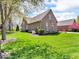 View of the lush green backyard, showcasing mature trees and well-maintained landscaping at 3559 Towne Dr, Carmel, IN 46032