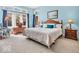 Serene bedroom with blue walls, a comfortable bed with decorative pillows, and ample natural light at 3559 Towne Dr, Carmel, IN 46032