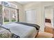 Bright bedroom with a comfortable bed, an open doorway, and large windows with decorative curtains at 3559 Towne Dr, Carmel, IN 46032