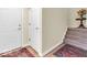 Inviting entryway with hardwood floors, an entry door, staircase, and a decorative area rug at 3559 Towne Dr, Carmel, IN 46032